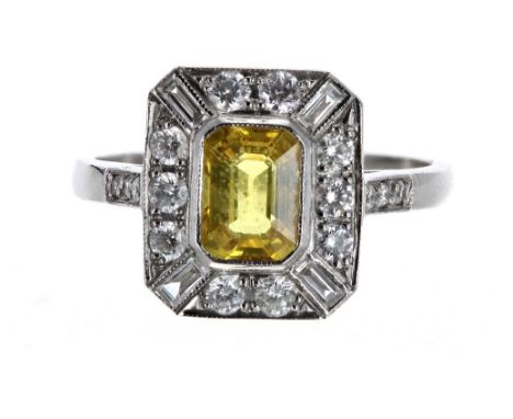 Art Deco style platinum yellow sapphire and diamond cluster ring with set shoulders, the sapphire 1.20ct, in a surround of ro