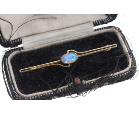 15ct black opal bar brooch, the oval opal 10mm x 6mm, 3.4gm, 58mm wide; with box 