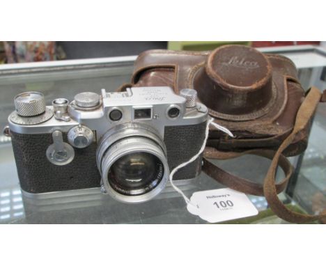 A Leica 35mm camera, number 696767, fitted with a Summicron 5cm 1:2 lens, in leather case