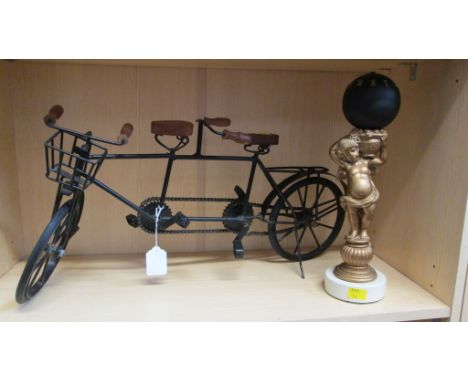 A reproduction globe clock, on a cherub support and a steel model of a tandem