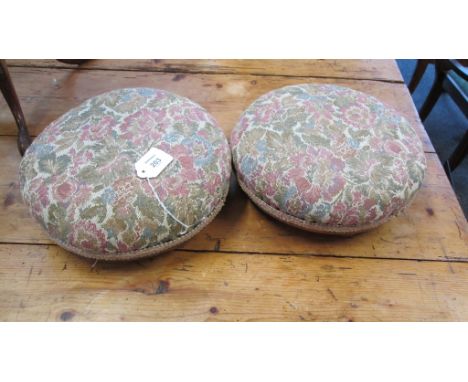 A pair of oak footstools, each of bun form with tapestry upholstered pads