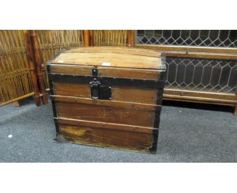 A pine, wood slatted and metal bound dome top trunk