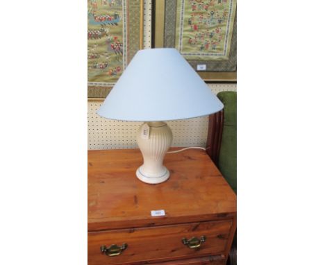 A contemporary white baluster ceramic table lamp with pale blue conical shade