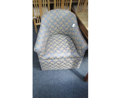 A tub shape salon armchair, upholstered in mustard floral print on a mid-blue ground