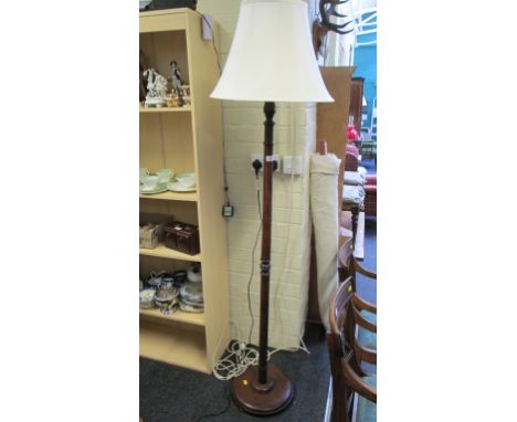 An oak standard lamp with cream silk shade
