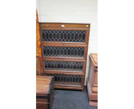 A 1930s oak Globe Wernicke type bookcase, in four sections, each with leaded glazed doors