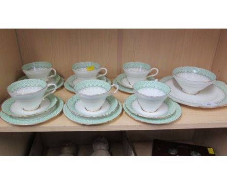 A Paragon six place tea service, comprising cups, saucers and side plates, cake plate and sugar, each decorated with a spray 