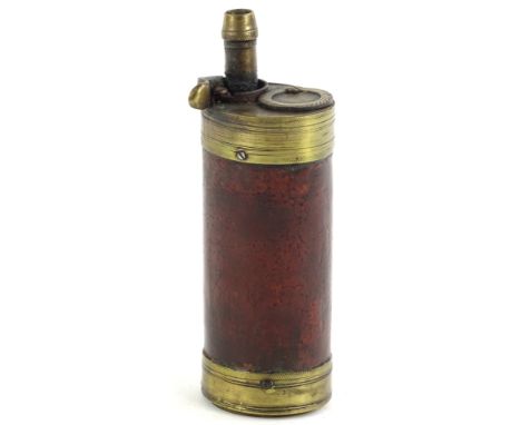 A 19thC brass and leather shot flask, of cylindrical form, 13cm H.