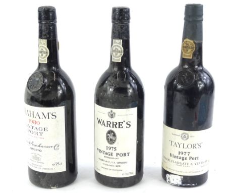 Three bottles of vintage port, Warre's 1975, Taylors 1977 and Grahams 1980.