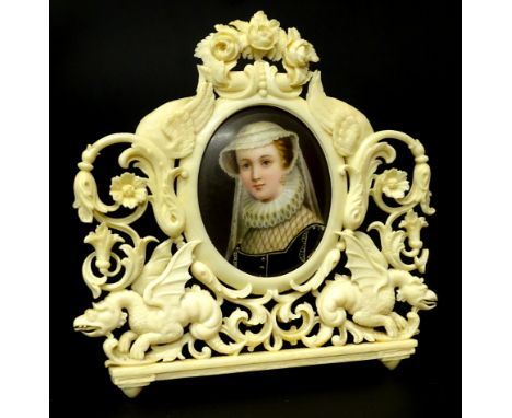 A 19thC Berlin porcelain plaque, portrait of a lady quarter profile on an unglazed back, in an elaborate ivory surround carve