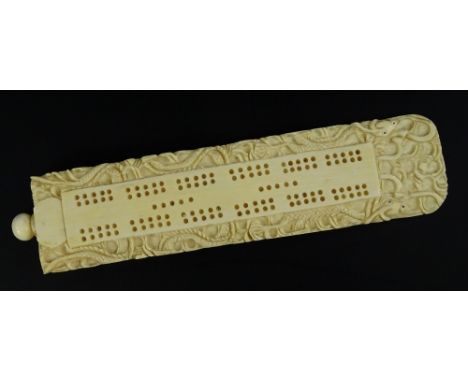 A late 19thC Chinese canton style ivory cribbage scorer, of wedge shape, decorated with stylised dragon etc., the screwed fin