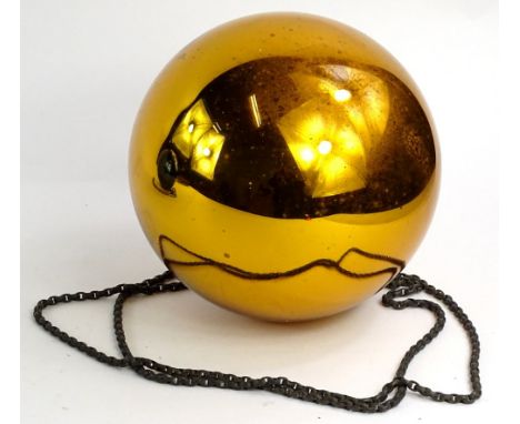 A 19thC gold coloured glass witches ball or bauble, 18cm diameter.
