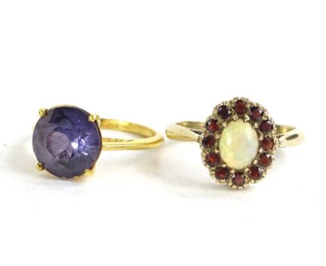 Two dress rings, to include a 9ct gold floral cluster ring, with central opal surrounded by garnets, 2.4g, and a gold plated 