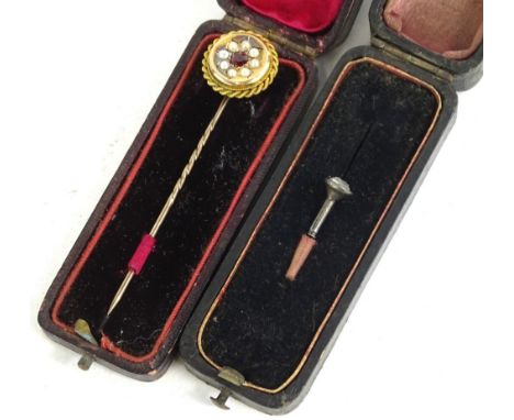 Two stickpins, to include a Victorian stick pin with large circular head, set with garnets surrounded by seed pearls, rope de