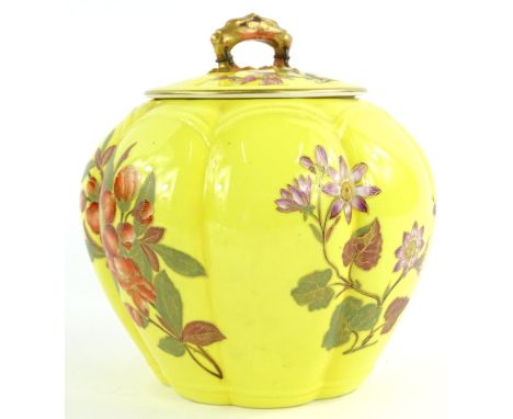 A Royal Worcester porcelain jar and cover, decorated with oriental style flowers on a yellow ground, printed in puce to under
