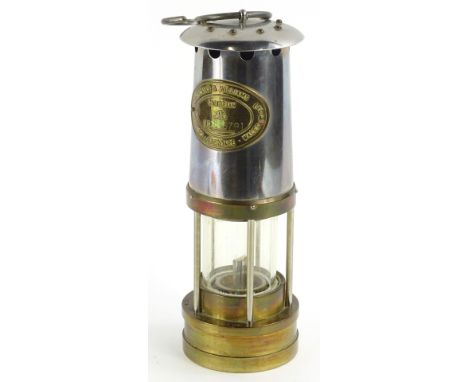 A brass and plated miners lamp, by Thomas and Williams of Aberdare, numbered 196791.