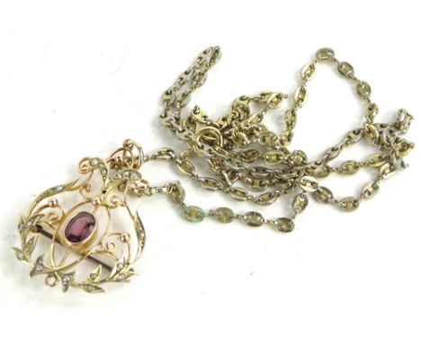 A Victorian Art Nouveau pendant, set with central garnet, surrounded by seed pearls with brooch conversion, a yellow metal st