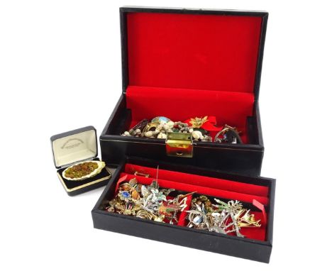 A black leatherette jewellery box and contents, including mainly decorative costume brooches of enamel type design, including