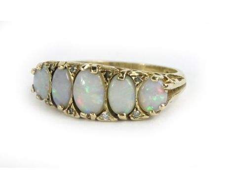 A 9ct gold opal and diamond dress ring, the ring head set with five oval cut opals and set with eight tiny diamonds, (1 missi