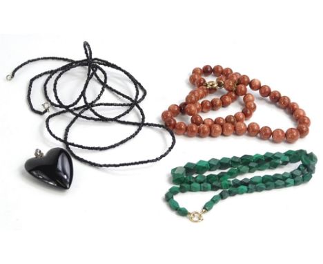 Four items of jewellery, to include a semi precious beaded necklace in orange glitter type colour, on a string necklace, with