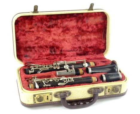 A Selmer Sterling black Bakelite or plastic clarinet, with plated mounts and various pieces in a fitted case.