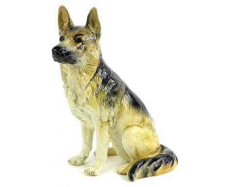 A large Beswick ceramic model of a seated German Shepherd or Alsatian, number 410 to underside, 34cm H.