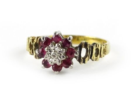 An 18ct gold cluster ring, the cluster set with central illusion set tiny diamond, surrounded by eight garnets, on pierced ba