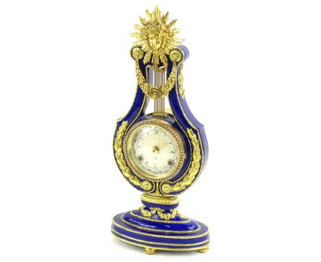 A Victoria and Albert Museum replica French mantel clock, the lyre shaped case with blue enamel decoration and gilt metal mou