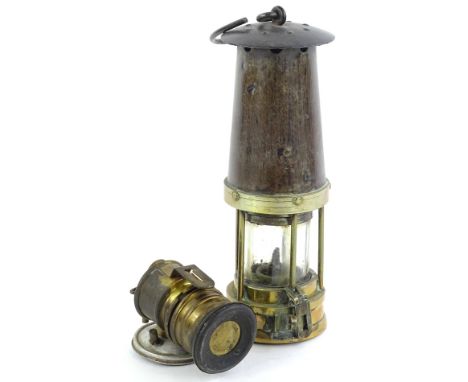 A brass and iron miner's lamp, unmarked, and a small Premiere brand lamp.