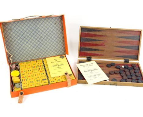 A wooden backgammon set in travelling case, and a mahjong set made by Jackpot in canvas case.