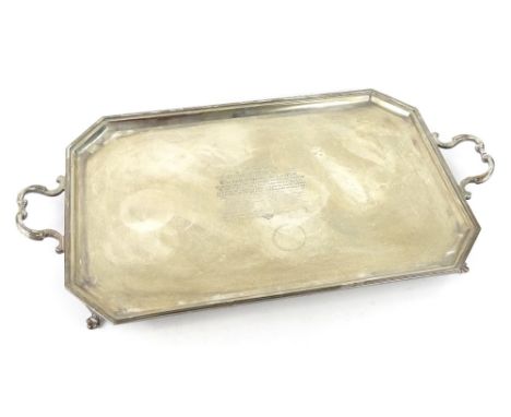 A George V canted rectangular two handled tray, engraved within an Art Deco cartouche, presented to Walter Hargreaves L.L.D, 