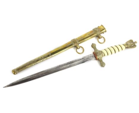 A German Third Reich naval dagger, with engraved brass scabbard, the blade stamped WKC with a stylised Roman soldier, ivorine