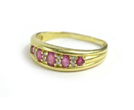 A ruby and diamond dress ring, with oval cut ruby's, flanked by tiny diamonds, the band misshapen, yellow metal, unmarked, 4.