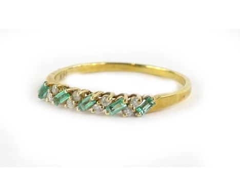 An 18ct gold emerald and diamond dress ring, set with baguette cut emerald stones, and round brilliant cut diamonds, in claw 