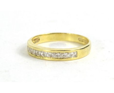 An 18ct gold diamond set dress ring, set with ten square cut diamonds in crossover setting, 2.7g all in.