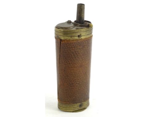 A 19thC brass and leather shot flask, of cylindrical form, 13cm H.