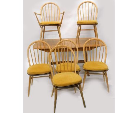 An Ercol blonde elm extending dining or kitchen table, with a moulded edge, rounded corners on trestle type supports, the top