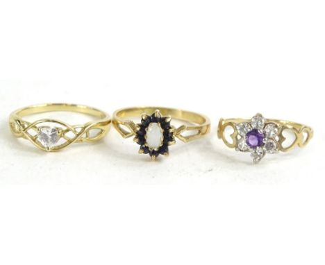 Three 9ct gold dress rings, to include a heart shaped cz dress ring, an opal and blue stone set floral cluster, a cz and amet