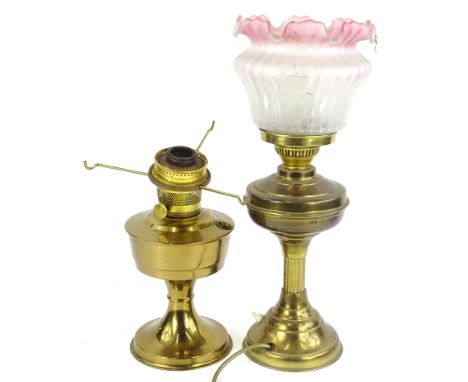 A brass oil lamp with Art Nouveau style etched shade, Art Nouveau style opaque glass shade and another similar brass base, on