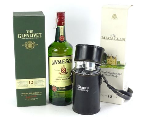 Three bottles of whisky, Glenlivet 12 years, Macallan 12 years, a Grants spirit flask and bottle of Jamesons Irish Whisky.