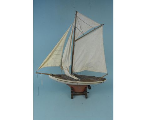 A vintage four sail wooden model yacht on wooden stand, 73cm tall (one wooden beam broken and rigging disturbed), approx. dim