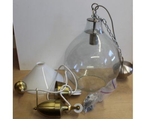 A large clear glass light fitting plus a brass light fitting