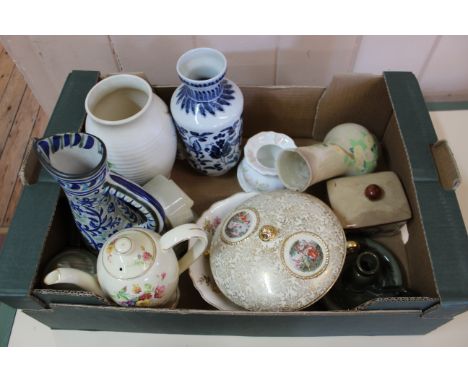 Three boxes of assorted items including glass decanters, pottery and porcelain jugs and vases, an oil lamp, binoculars etc
