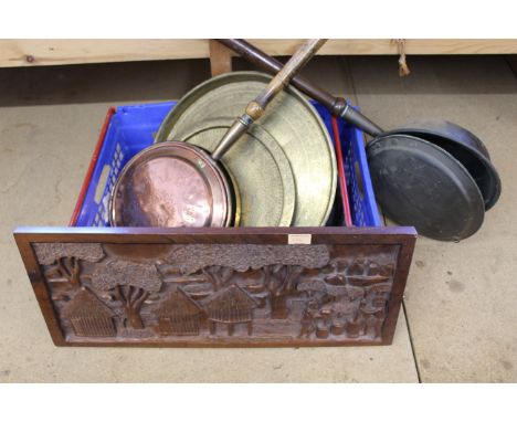 Two Indian brass trays plus one other, the largest being 47cm dia, an African carved wooden plaque with village scene and far