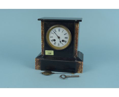 A late 19th Century black marble mantel clock with porcelain dial and red marble columns