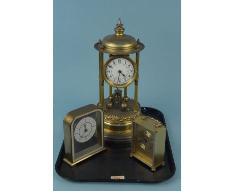 A vintage brass torsion clock (lacking dome, for restoration) plus two mantel clocks