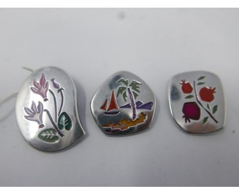 Three Israeli, sterling silver and hand-enamelled brooches of contemporary design, decorated with designs of a cyclamen flowe