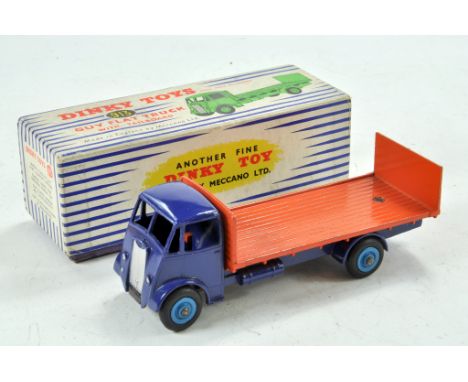 Dinky Toys No. 913 Guy Flat Truck with Tailboard. Deep blue body and chassis with orange flatbed back. Light blue hubs in blu