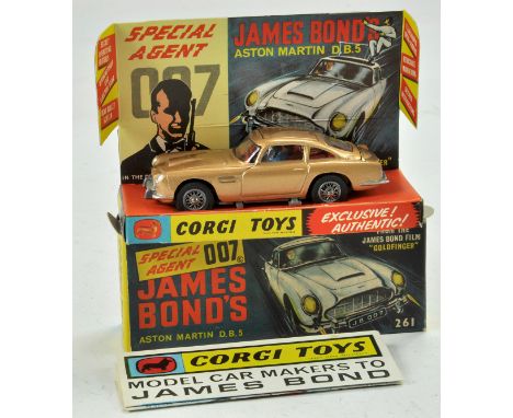 Corgi No. 261 James Bond 007 Aston Martin DB5. Gold Body with red interior, with figures. Complete with secret instructions, 