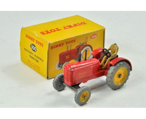 Dinky No. 300 Massey-Ferguson Tractor. Red body and yellow cast wheels, unpainted tyres. 'Massey Harris' on side of tractor. 